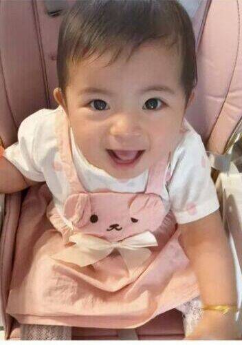 Real customer photo: a happy baby wearing the Little Haven Bunny Buddy Pinafore Dress, shared on Instagram by a parent